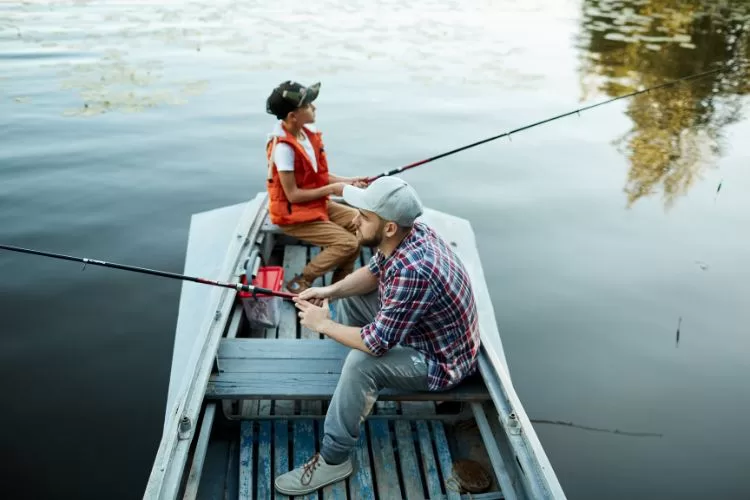 Father and son finishing on a boat